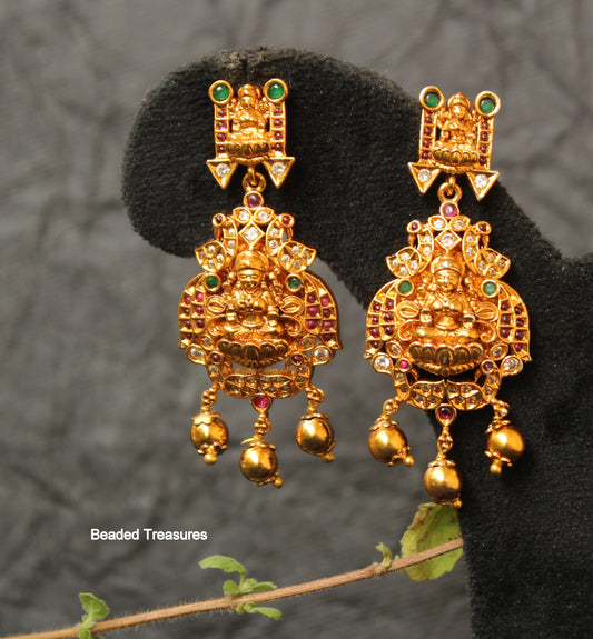 Royal Matte Gold Lakshmi Devi Dangling Earrings with Kemp, Emerald & White Stones - Beaded Treasures